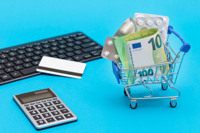 High angle view of miniature shopping cart on table