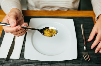 Midsection of woman holding food on table