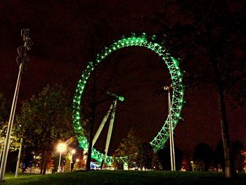 Illuminated ferris wheel at night