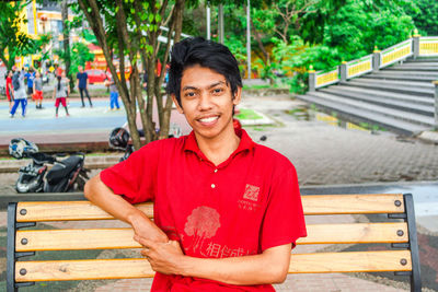 Portrait of smiling young man standing outdoors