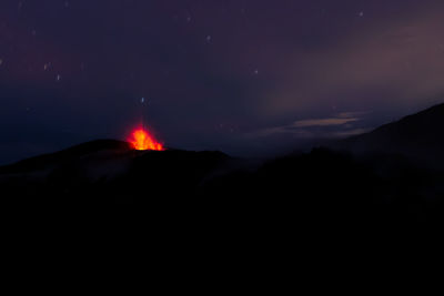 Scenic view of silhouette mountain against sky at night