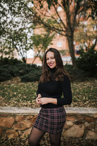 Portrait of a smiling young woman standing outdoors