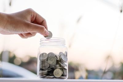 Close-up of hand holding glass jar