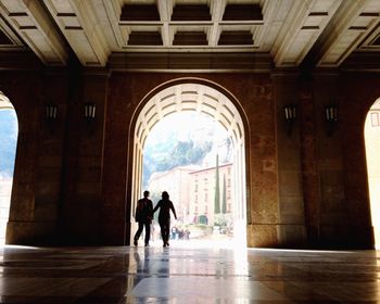 Silhouette couple walking in lobby