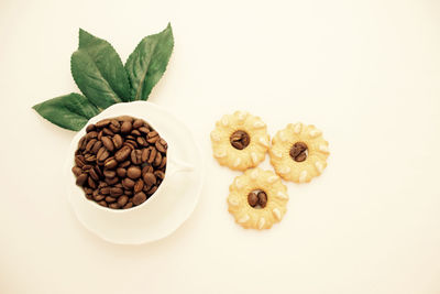 High angle view of coffee beans against white background