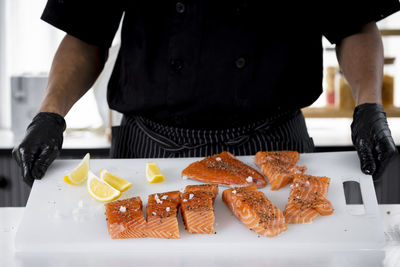 Midsection of man preparing food