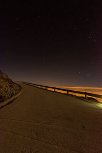 Scenic view of road against sky at night