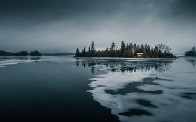 Scenic view of frozen lake against sky during winter