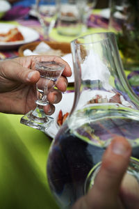 Hand holding shot glass, sweden