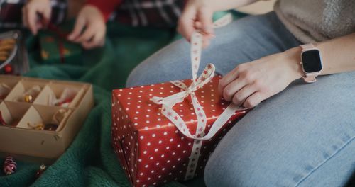 Midsection of woman holding gift