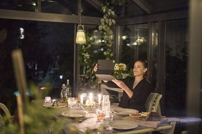 Woman at table using digital tablet