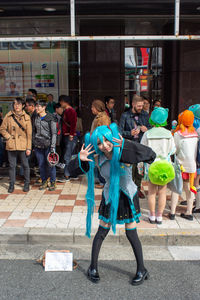 Group of people standing on street in city