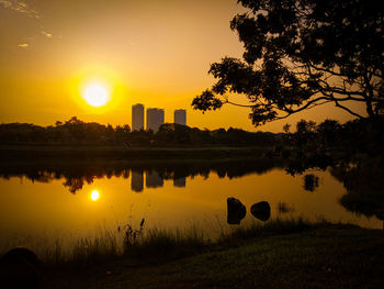 Scenic view of lake against sky during sunset