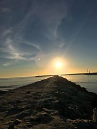 Scenic view of beach against sky during sunset