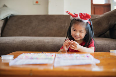 Cute girl doing craft at home