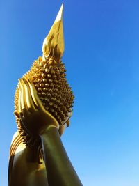 Low angle view of statue against blue sky