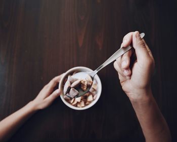 Cropped image of person having breakfast at home