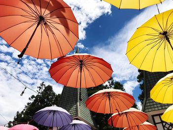 Low angle view of umbrellas against sky