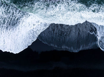 Iceland black sand beach with huge waves at reynisfjara vik.