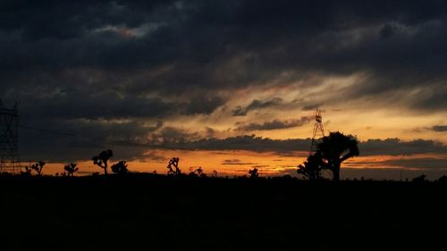 Silhouette of landscape against cloudy sky