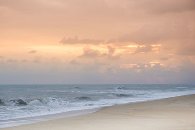 Scenic view of beach at sunset