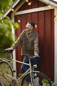 Side view of young woman riding bicycle