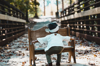 Rear view of child on a bridge