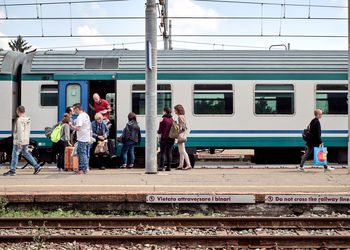People waiting train at railroad station platform