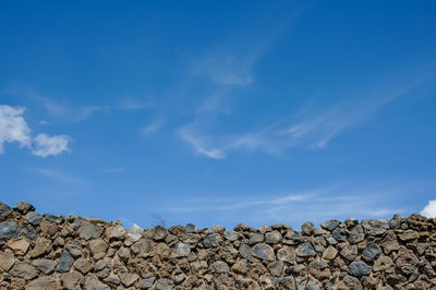 Stack of rocks against blue sky