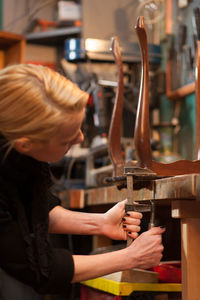 Close-up of craftsperson working at workshop