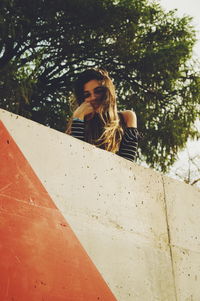 Low angle portrait of woman against plants