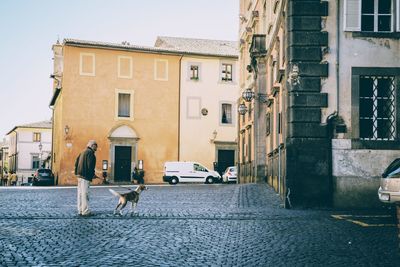 Street amidst buildings in city against sky