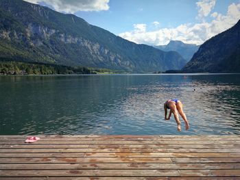 Full length of boy on lake against sky