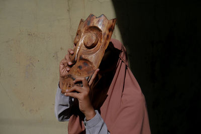 Women in a traditional wooden mask.