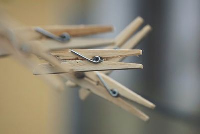 Close-up of clothespins on rope outdoors