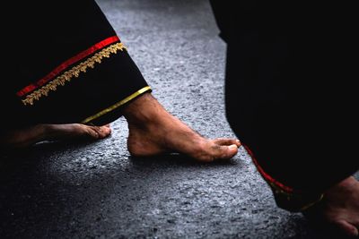 Low section of man holding hands