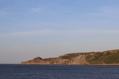 Scenic view of sea and cliff