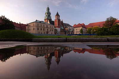 Reflection of wawel cathedral on puddle