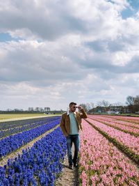 Men walking in flower field in the netherlands 
