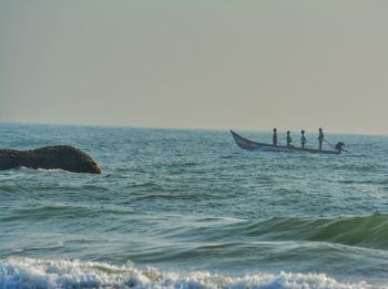 Man in sea against clear sky