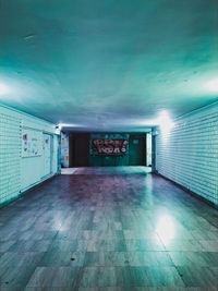 Empty corridor in illuminated building