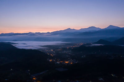 Scenic view of silhouette mountains against sky during sunset