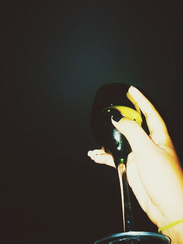 part of, studio shot, copy space, cropped, indoors, person, close-up, personal perspective, yellow, black background, holding, still life, unrecognizable person, human finger, food and drink, shoe, high angle view