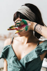 Portrait of young woman eating outdoors