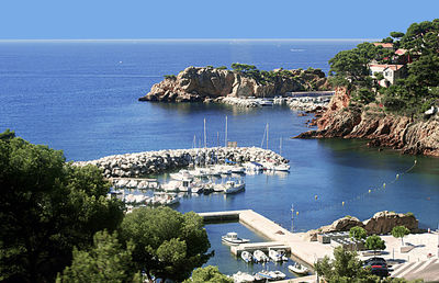 High angle view of townscape by sea against sky