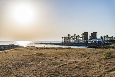 Scenic view of beach against sky during sunset