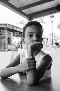 Portrait of boy sitting on table
