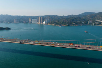 High angle view of city by sea against sky