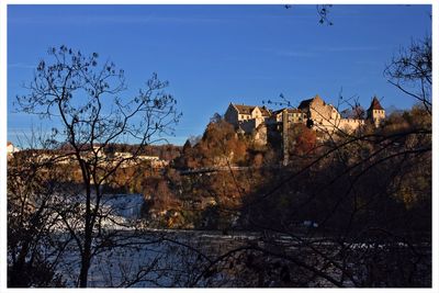 Low angle view of castle against clear blue sky