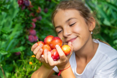 Portrait of boy holding tomatoes